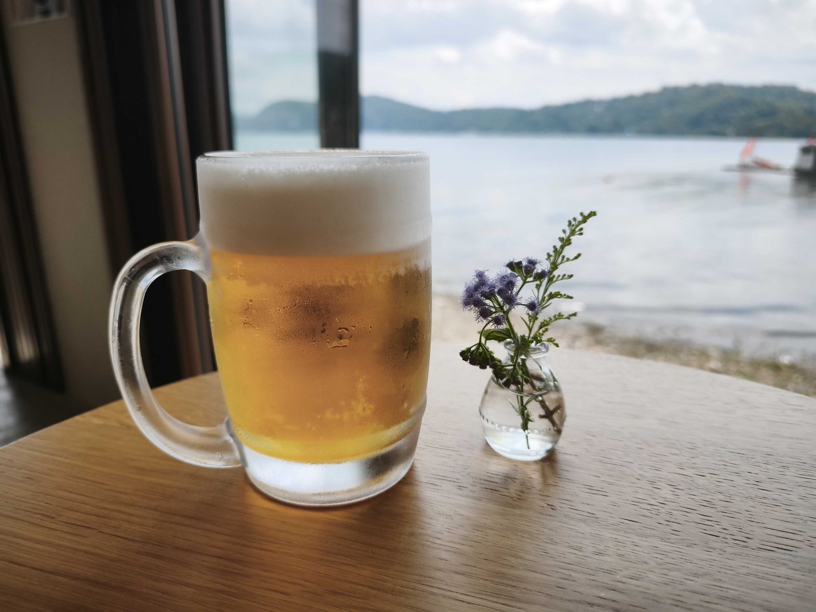 野尻湖を望む窓際のテーブルに置かれたサントリー生ビールの中ジョッキ
